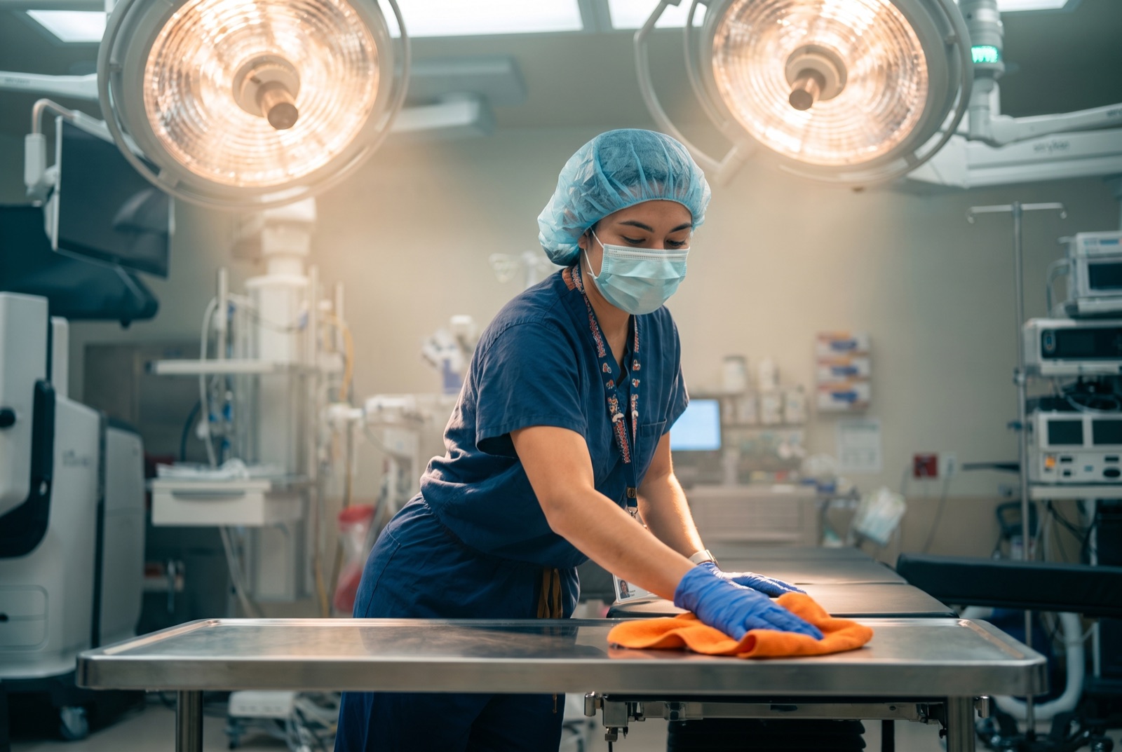 Vector technician disinfecting the surgical table