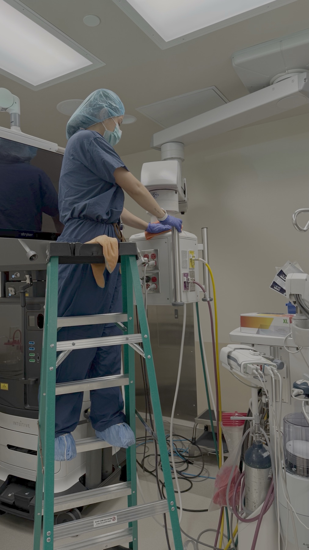 Technician on ladder over OR equipment