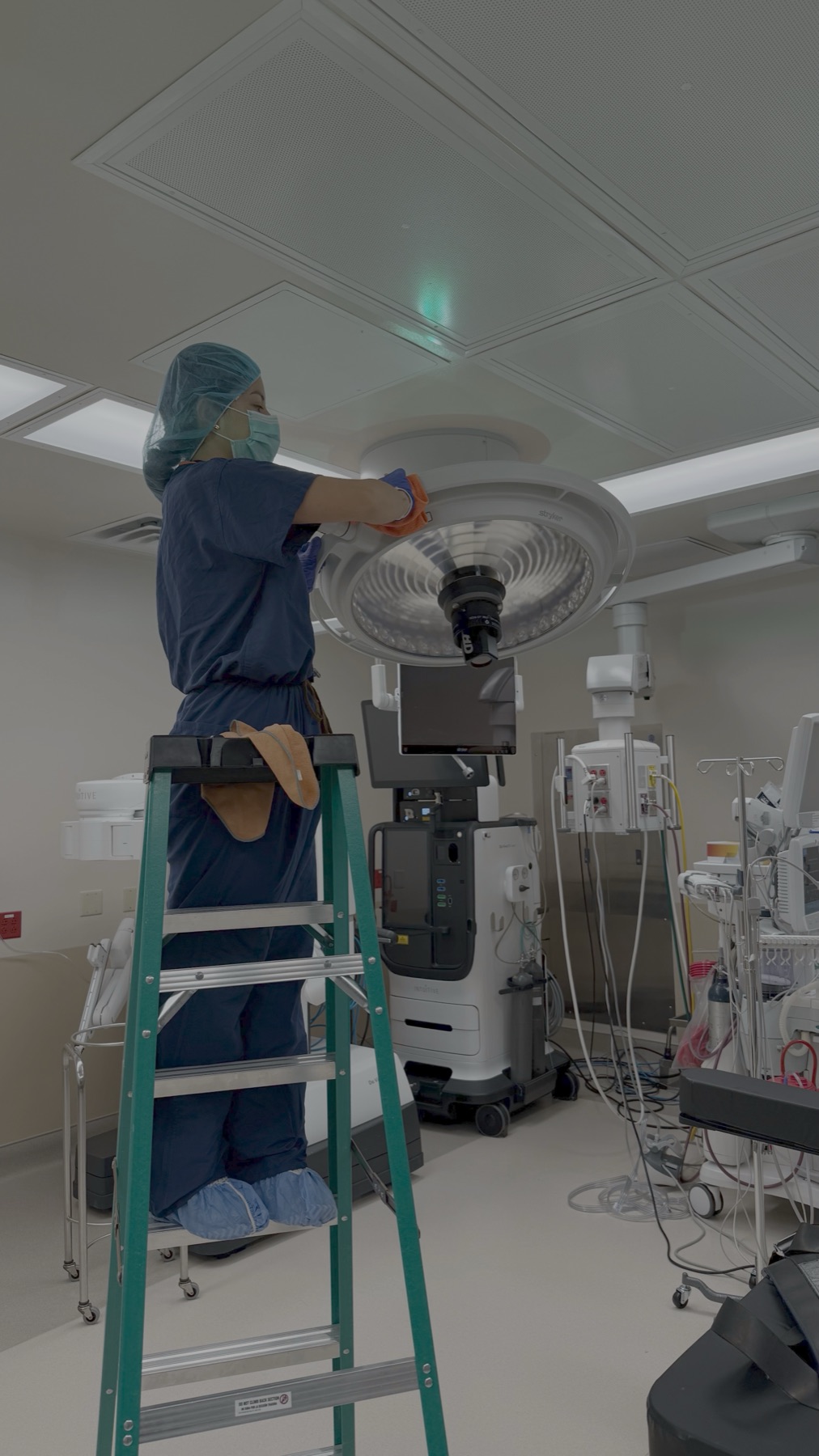 Ladder work beside robotic surgical arms